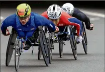  ?? STEPHEN POND / GETTY IMAGES ?? Daniel Romanchuk of the U.S. leads the pack on his way to winning the Men’s Elite Wheelchair race during the Virgin Money London Marathon this past spring.