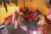  ?? MANISH SWARUP — THE ASSOCIATED PRESS ?? Sikh farmers sit inside their makeshift tent at Singhu, the Delhi-Haryana border camp for protesting farmers against three farm bills, in New Delhi, India, Wednesday.