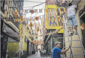  ?? S. RODRÍGUEZ ?? Colocación de farolillos y banderines, antes de empezar la feria.