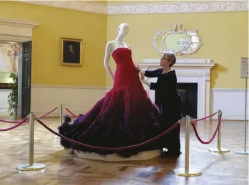  ??  ?? A curator examines a dress at the Fashion Museum, Bath. History graduates are equipped to work in multiple job sectors including law, the civil service and heritage