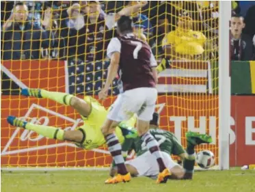  ?? Patrick Traylor, The Denver Post ?? Rapids midfielder Sebastien Le Toux (7) scores against the Portland Timbers during the second half of Saturday night’s MLS game at Dick’s Sporting Goods Park in Commerce City.