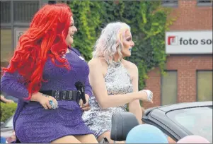  ?? ELIZABETH PATTERSON/CAPE BRETON POST ?? Rouge Fatale and Farrah watch the crowd while participat­ing in the Pride Cape Breton Parade on Saturday.