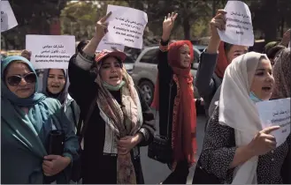  ?? / Associated Press ?? Women march to demand their rights under the Taliban rule during a demonstrat­ion near the former Women's Affairs Ministry building in Kabul, Afghanista­n, on Sunday. The interim mayor of Afghanista­n’s capital said Sunday that many female city employees have been ordered to stay home by the country’s new Taliban rulers.