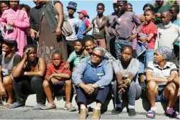  ?? PICTURE: SIPHEPHILE SIBANYONI ?? SEEKING SOLUTION: Vrygrond councillor Gerry Gordon with residents while waiting for confirmati­on that mayor Patricia de Lille would hold talks with residents on Wednesday on their demand for housing.