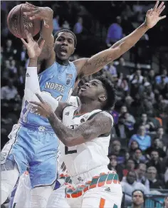  ?? Julie Jacobson ?? The Associated Press North Carolina guard Kenny Williams, rear, blocks a shot by Miami guard Chris Lykes in the second half of the No. 12 Tar Heels’ 82-65 win Thursday at Barclays Center.