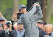  ?? AFP ?? Tiger Woods plays a shot from the 14th tee in the first round.