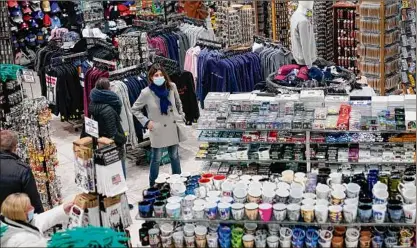  ?? ?? People shop at Grand Slam, a souvenir and sports apparel store, in New York’s Times Square.