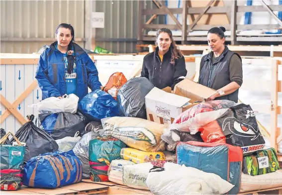  ?? ?? Volunteers Getting ready to distribute the mountain of donations delivered by Merson Group