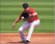  ?? John Bazemore / Associated Press ?? Red Sox first baseman Bobby Dalbec fields a ground ball in the first inning off a spring training game against the Braves on March 10 in Fort Myers, Fla..