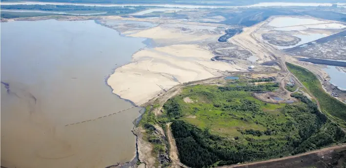  ?? Ryan Jackson/Edmonton Journal ?? An aerial view of Suncor’s tailings pond 6, which was once the company’s original mid-1960s open-pit mine