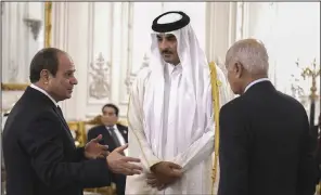  ?? ?? Egyptian President Abdel Fattah el-Sissi (left) and Secretary-General Ahmed Aboul Gheit talk to Qatari Emir Sheikh Tamim bin Hamad Al Thani on Saturday during the internatio­nal peace summit at the New Administra­tive Capital, just outside Cairo.
(AP/Egyptian Presidency Media Office)