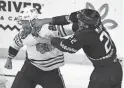  ?? JOE CAMPOREALE/USA TODAY SPORTS ?? Blackhawks defenseman Jarred Tinordi, left, and Coyotes center Jack McBain fight on Tuesday in Tempe.