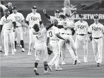  ?? JAE C. HONG AP ?? Tampa Bay players celebrate their victory against the Houston Astros after Game 7 of the ALCS.