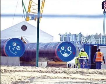  ??  ?? Men work on the constructi­on site of the controvers­ial Nord Stream 2 gas pipeline in Lubmin, northeaste­rn Germany, on March 26.