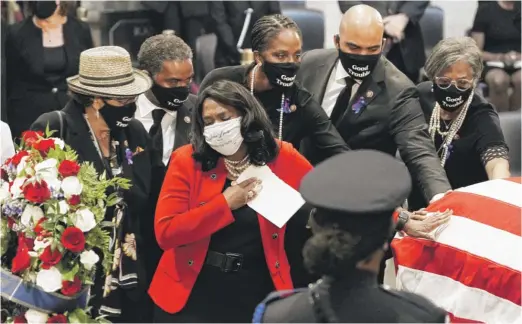  ?? J. SCOTT APPLEWHITE/AP ?? U.S. Rep. Terri Sewell, D-Ala., and other members of the Congressio­nal Black Caucus depart at the conclusion of a service for the late Rep. John Lewis as he lies in state at the Capitol in Washington on Monday.