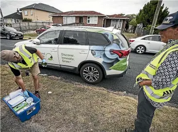  ??  ?? Ministry for Primary Industries staff set up traps and mark fruit trees in O¯ tara, South Auckland, after another fruitfly was found, although a different type from the ones found on the North Shore. LAWRENCE SMITH/STUFF