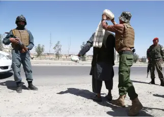  ??  ?? Afghan security soldiers search a man at a checkpoint, ahead of Eid Al-Fitr festivitie­s, at the market in Ghazni province on Saturday. (AFP)