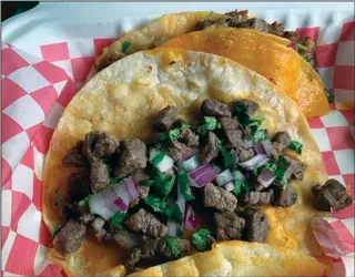  ?? (Arkansas Democrat-Gazette/Eric E. Harrison) ?? Lili’s Mexican Street Food truck Carne Asada (foreground) and Quesabirri­a tacos perhaps come from somewhat swankier streets.