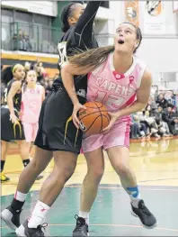  ?? VAUGHAN MERCHANT/CAPE BRETON UNIVERSITY ?? Alison Keough of the Cape Breton University Capers makes room against defender Roberta Charles of the Dalhousie Tigers in AUS play at the Sullivan Fieldhouse Friday night. Keough led the team with 28 points and 15 rebounds in an 83-63 win.