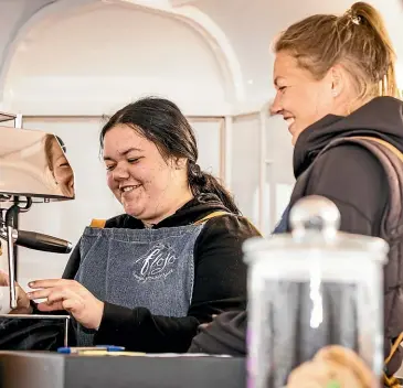  ?? VANESSA LAURIE/ STUFF ?? For the next 12 weeks, Stratford teenager Grace Kahui will train alongside barista Anita Oliver, who runs the Flo Jo coffee cart.