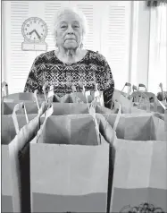  ?? RACHEL DICKERSON/MCDONALD COUNTY PRESS ?? Louine Gardner, director of the Noel Senior Center, is pictured with food bags that will be distribute­d to home-bound seniors around McDonald County.