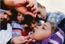  ?? Reuters ?? A girl is given vitamin A drops during a house-to-house vaccinatio­n campaign in Yemen on Monday.