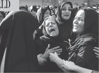  ?? EBRAHIM NOROOZI / THE ASSOCIATED PRESS ?? Families mourn the victims of Saturday’s terror attack on a military parade in the southwest Iranian city of Ahvaz, which killed 25 people, at a mass funeral ceremony on Monday.