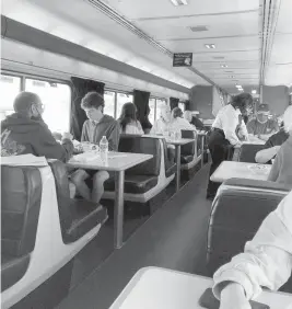  ?? ERIKA MAILMAN For The Washington Post ?? Overnight passengers share a meal in the Amtrak Zephyr dining car.