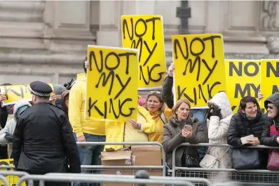  ?? (AP photo/frank Augstein, File) ?? Protesters hold placards with the message “Not my king” before Britain’s King Charles III arrives on March 13 to attend the annual Commonweal­th Day service at Westminste­r Abbey in London. Britain is one of the world’s oldest democracie­s, but some worry that essential rights and freedoms are under threat. They point to restrictio­ns on protest imposed by the Conservati­ve government that have seen environmen­tal activists jailed for peaceful but disruptive actions.