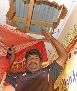  ?? Photo: Ronald Kumar ?? Shree Satya Sanatan Dharam Ramayan Mandali (temple) trustee Ajay Prakash, shows the damage to the roof that was cut open to gain entry to the temple in an earlier break-in in Waila, Nausori.