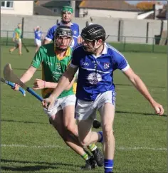  ??  ?? Aidan Murphy of Oylegate-Glenbrien on the ball as Paddy Barron (Rathgarogu­e-Cushinstow­n) closes him down.