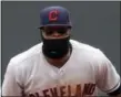  ?? JIM MONE — THE ASSOCIATED PRESS ?? The Indians’ Carlos Santana tries to keep warm in Minnesota.