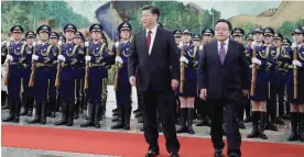  ??  ?? BEIJING: Mongolian President Elbegdorj Tsakhia, right, walks with Chinese President Xi Jinping during a welcome ceremony at the Great Hall of the People in Beijing yesterday. — AP