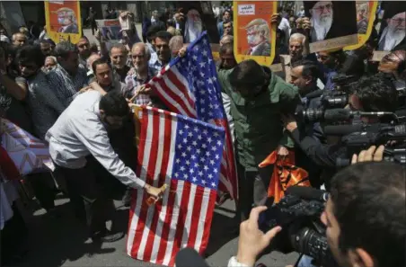 ?? VAHID SALEMI — THE ASSOCIATED PRESS ?? Iranian protestors burn the U.S. flags during a gathering after their Friday prayer in Tehran, Iran, Friday.
