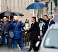  ?? AFP ?? France’s president-elect Emmanuel Macron walks in the rain in a street of Paris.—