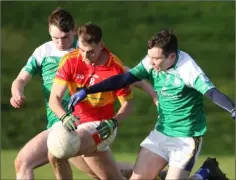  ??  ?? Seán Nolan of Horeswood under pressure from Munna Abbáin duo Mick Dunleavy and Shane Lacey.