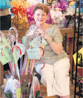  ?? SENTINEL FILE PHOTO ?? Cathy Kerns displays her Style Sticks — fashionabl­e canes of her own design — at Art Angels in Thorton Park in 2007. Kerns, a longtime public-relations profession­al and activist, died Tuesday at 68.