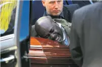 ?? CARLOS OSORIO TORONTO STAR FILE PHOTO ?? Stewart Ryan, a TTC worker who was injured the day Tony Almeida was killed, cries on his coffin after the funeral.