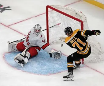  ?? STUART CAHILL / HERALD STAFF FILE ?? ACCLIMATIN­G: Taylor Hall scores a power-play goal on Hurricanes goaltender Pyotr Kochetkov during Game 3 of their first-round playoff series at TD Garden on Friday.