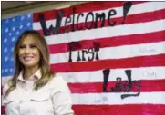  ?? ANDREW HARNIK — THE ASSOCIATED PRESS ?? First lady Melania Trump smiles after signing American flag artwork while visiting the Upbring New Hope Children Center run by the Lutheran Social Services of the South in McAllen, Texas, Thursday.