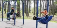  ??  ?? Children swing at a community park in Boyertown. A visit to a park or playground can provide outdoor exercise opportunit­ies for all children.