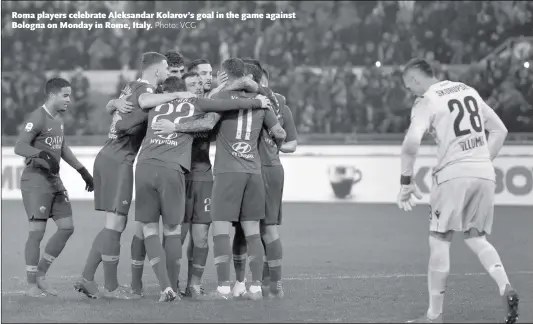  ?? Photo: VCG ?? Roma players celebrate Aleksandar Kolarov’s goal in the game against Bologna on Monday in Rome, Italy.