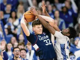  ?? Rebecca S. Gratz/Associated Press ?? UConn's Donovan Clingan, left, plays against Creighton's Fredrick King on Saturday in Omaha, Neb.