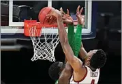  ?? JEFF ROBERSON / AP ?? Southern California forward Evan Mobley (4) dunks the ball over Oregon center Franck Kepnang, left, during the second half of a Sweet 16 game in the NCAA men’s college basketball tournament at Bankers Life Fieldhouse Sunday in Indianapol­is.