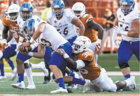  ?? Tim Warner / Getty Images 2017 ?? San Jose State QB Sam Allen is sacked by Texas’ Edwin Freeman last season in a game for which SJSU was paid $1 million.