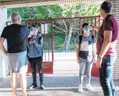  ?? PHOTO: AFP ?? Measures:
Students’ temperatur­es are checked as they arrive at Axular Lizeoa school in San Sebastian after the reopening of schools in Spain’s Basque Country.