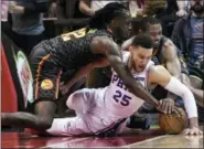  ?? JOHN AMIS — THE ASSOCIATED PRESS ?? Philadelph­ia 76ers guard Ben Simmons (25) dives to the floor for a loose ball with the Atlanta Hawks’ Taurean Prince and Isaiah Taylor during Tuesday’s game.