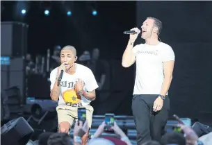  ?? JEMAL COUNTESS GETTY IMAGES ?? A good cause: Pharrell Williams and Chris Martin perform during the Global Citizen Festival: Mandela 100 on Sunday in Johannesbu­rg. This event is part of a campaign to end poverty.