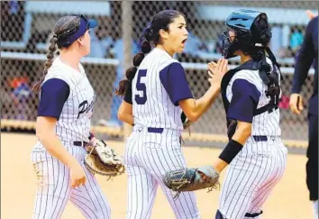  ?? Nick Koza For The Times ?? PACIFICA PITCHER Brynne Nally (5) is fired up and slaps hands with catcher Catherine Benitez after retiring the side against Norco during the Division 1 championsh­ip game. Nally pitched all seven innings in a win.