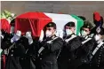  ?? | Reuters ?? CARABINIER­I officers carry one of two coffins containing the bodies of the Italian ambassador to DRC and his bodyguard, in Rome yesterday.